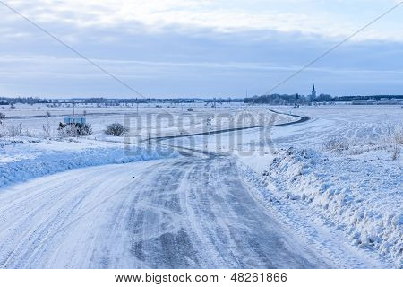 Countryside Road Through Winter Field