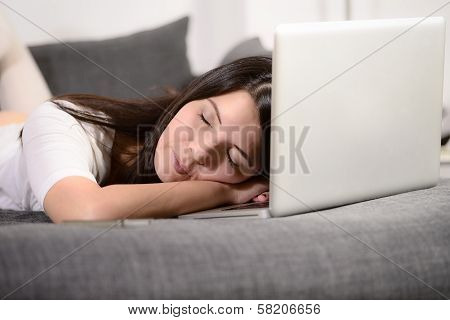 Tired Woman Sleeping On The Laptop Keyboard