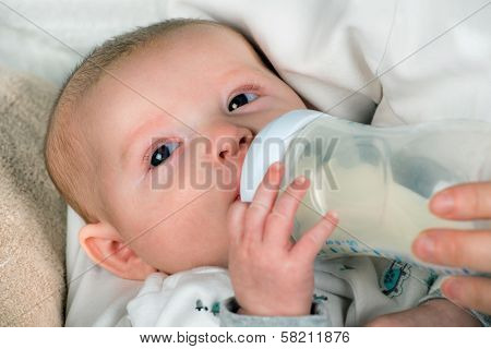 Infant baby feeding from bottle