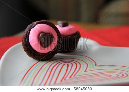 Chocolate brownie bites with pink frosting