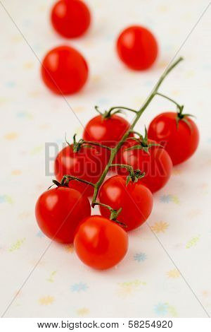 Closeup of cherry tomatoes on the vine.