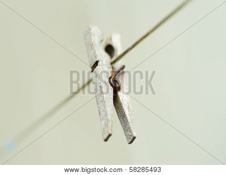 Old Wooden Clothespeg Hanging On Rope. Blur Background