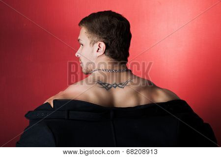 muscular man in a coat.
