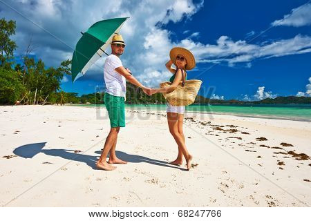 Couple in green on a tropical beach at Seychelles