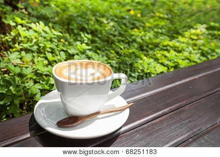 Cup of latte coffee on wooden