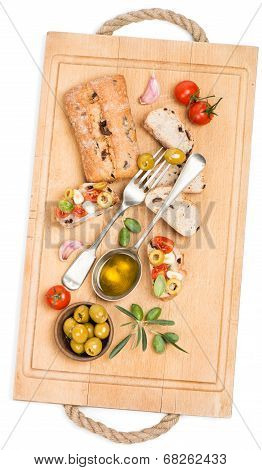 Bread With Tomato, Garlic And Olives On The Wooden Board