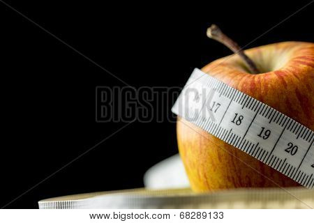 Fresh Tasty Apple Wrapped With A Measuring Tape