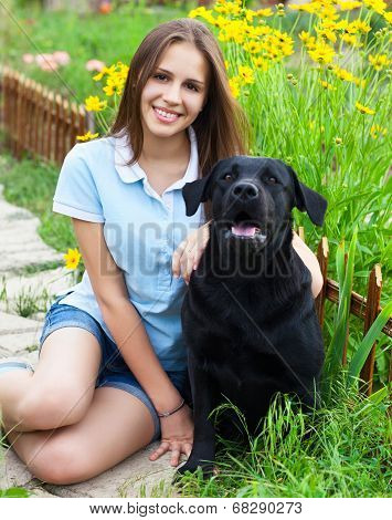 Teenager Girl With Black Labrador Retriever