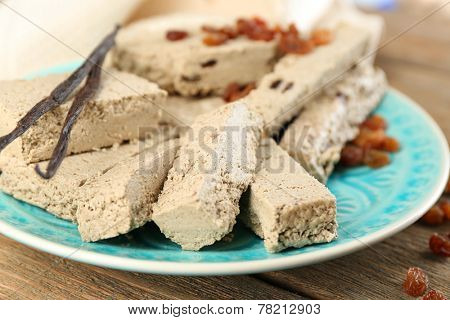 Two kinds of sunflower halva - with raisinas and vanilla taste. on plate, on wooden background