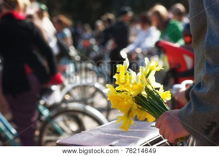 Man With Yellow Flowers In A Group Of Cyclists In Spring
