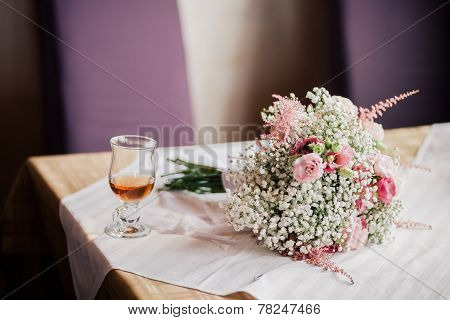Wedding Bouquet  And  A Cup Of Tea On The Table