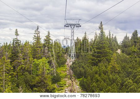 cableway leading to the mountain in the Czech Republic Sn??ka on the background of spruce forest