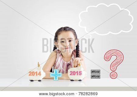 Little Girl thinking about Saving Money On A Piggy Bank With A New Year 2015.