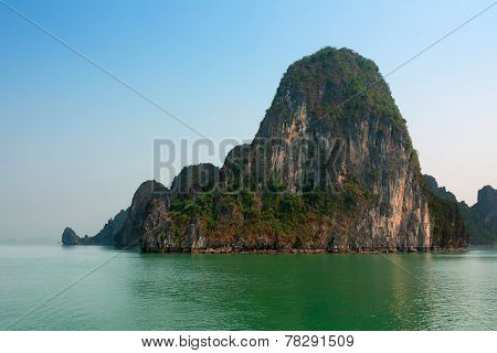 Halong Bay Vietnam With Tourist Boats And Hazy Blue Sky