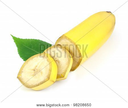 Sliced fresh banana with green leaf isolated on white