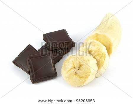 Sliced and peeled banana with chocolate pieces isolated on white