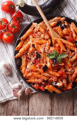 Italian Food: Pasta Alla Norma Close-up And Ingredients. Vertical Top View