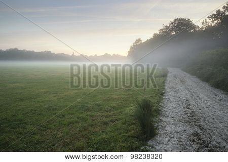 Misty Landscape During Sunrise In English Countryside Landscape