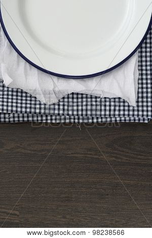 Vintage Enamelware Crockery On Retro Cloths On Rustic Wooden Background