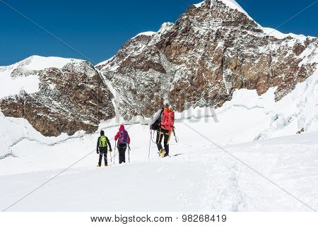 Group of climbers walking on a glacier.
