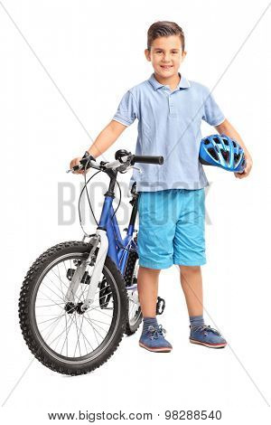 Full length portrait of a little kid posing with his bicycle and holding a blue helmet in his hand isolated on white background