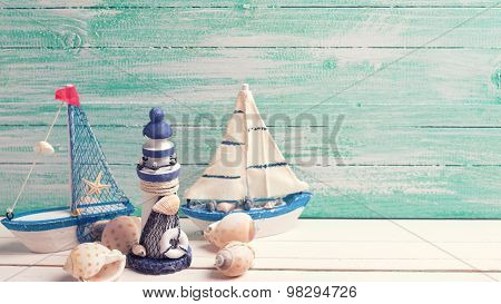 Decorative Lighthouse,  Sailing Boats And Marine Items On Wooden Background.