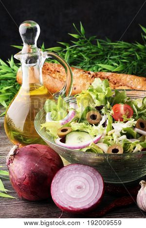 Bowl Of Salad With Vegetables And Greens On Wooden Table