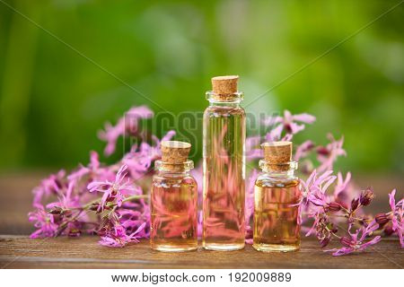 Essence Of Flowers On Table In Beautiful Glass Jar