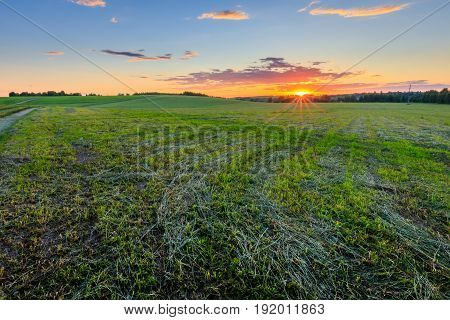Sunset At Cultivated Land In The Countryside On A Summer.