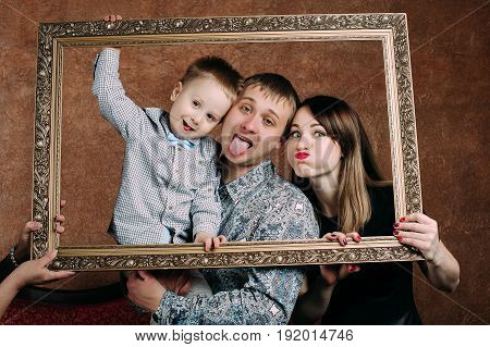 Three Generation Family Sitting On Sofa Together. Classic portrait in a frame