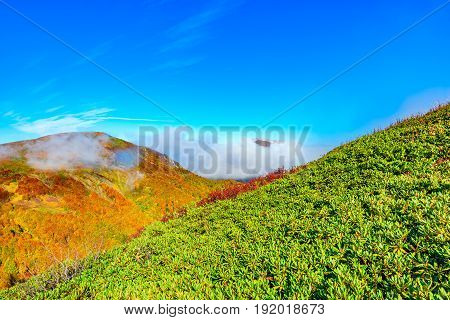 Clouds cover the mountain tops at autumn evening time. Caucasus. Russia.