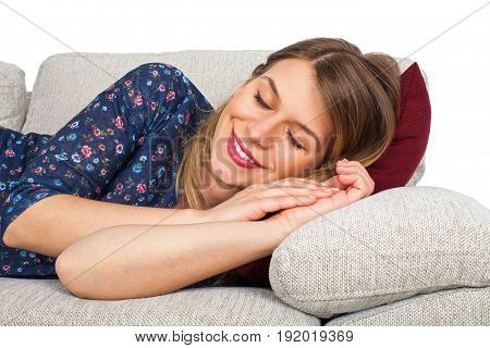 Picture of a beautiful young woman lying on the couch at home indoor