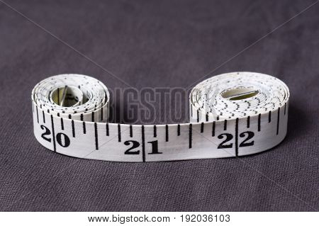 Inch, Centimeter Tape Tailor Folded In The Form Of Eight