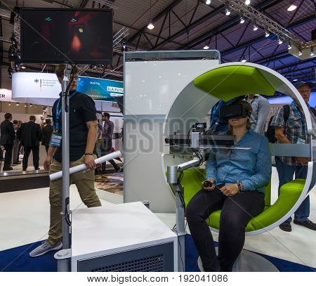 BERLIN GERMANY - JUNE 01 2016: The stand of Airbus Group. Flight simulator based on virtual reality glasses Oculus Rift. Exhibition ILA Berlin Air Show 2016.