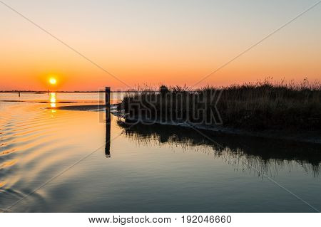 Italy Po delta park sunset on the Goro lagoon