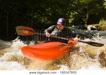 Bala Wales UK - June 18 2017: White water kayaker shooting the rapids at the National White Water Centre on the River Tryweryn in Snowdonia National Park