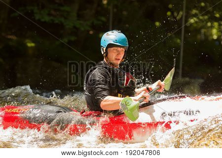 Bala Wales UK - June 18 2017: White water kayaker shooting the rapids at the National White Water Centre on the River Tryweryn in Snowdonia National Park