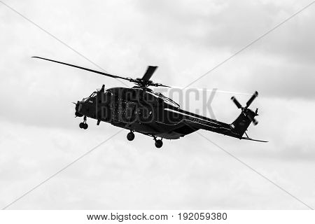 BERLIN GERMANY - JUNE 02 2016: Helicopter NH90 of the German Army. Demonstrative performance. Black and white. Exhibition ILA Berlin Air Show 2016