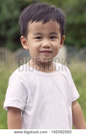 outdoor portrait head shot of asian children smiling face looking with eyes contact to camera