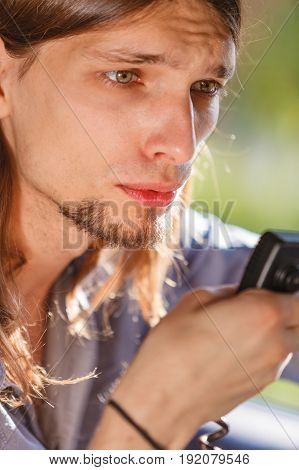 Talking while drive auto walkie talkie comunication concept. Young man driving car using cb radio
