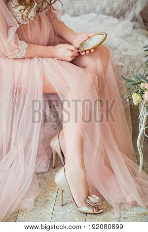 A young, tender pregnant is holding a vintage mirror
