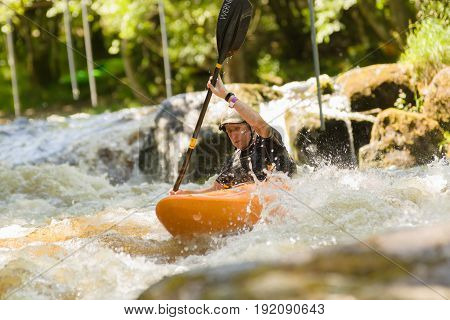 Bala Wales UK - June 18 2017: White water kayaker shooting the rapids at the National White Water Centre on the River Tryweryn in Snowdonia National Park