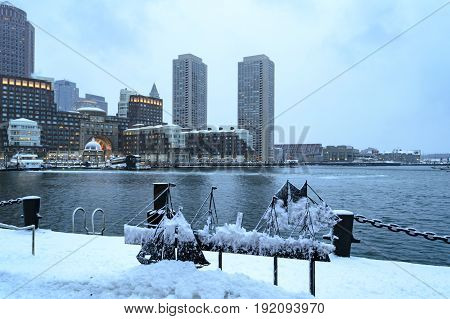 South Boston Massachusetts USA- February 16 2017: Snow covers Harborwalk along Fan Pier with Rowes Wharf in background