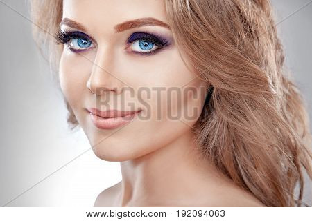 High fashion look close up beauty portrait of beautiful young woman model with bright makeup with perfect clean skin