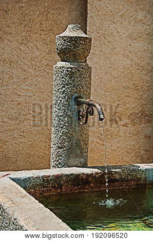 Close-up of stone fountain in Megève, a famous ski resort located in Haute-Savoie Province, near the Mont Blanc French Alps. Retouched photo