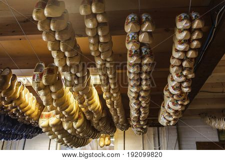 Row of blank new wooden Dutch clogs for sale on a marketMarken The Netherlands