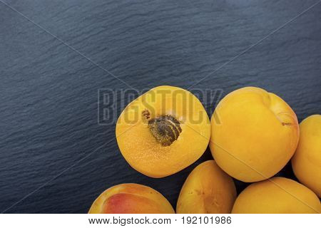 Ripe Apricot On Black Background Of Slate Or Stone