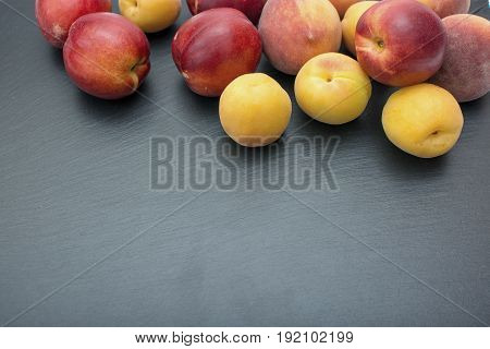 Ripe Apricot And Nectarine On Black Background Of Slate Or Stone