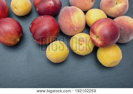 Ripe Apricot And Nectarine On Black Background Of Slate Or Stone