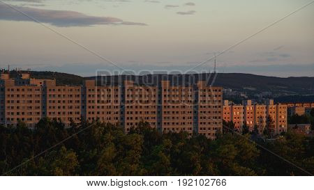 Old prefabricated housing estates in the outskirts of a town at sunset